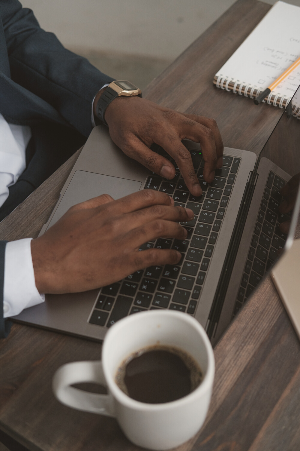 Man Typing on Laptop